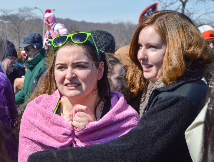 Tara Carlson warms up her friend who participated in the Polar Plunge.
